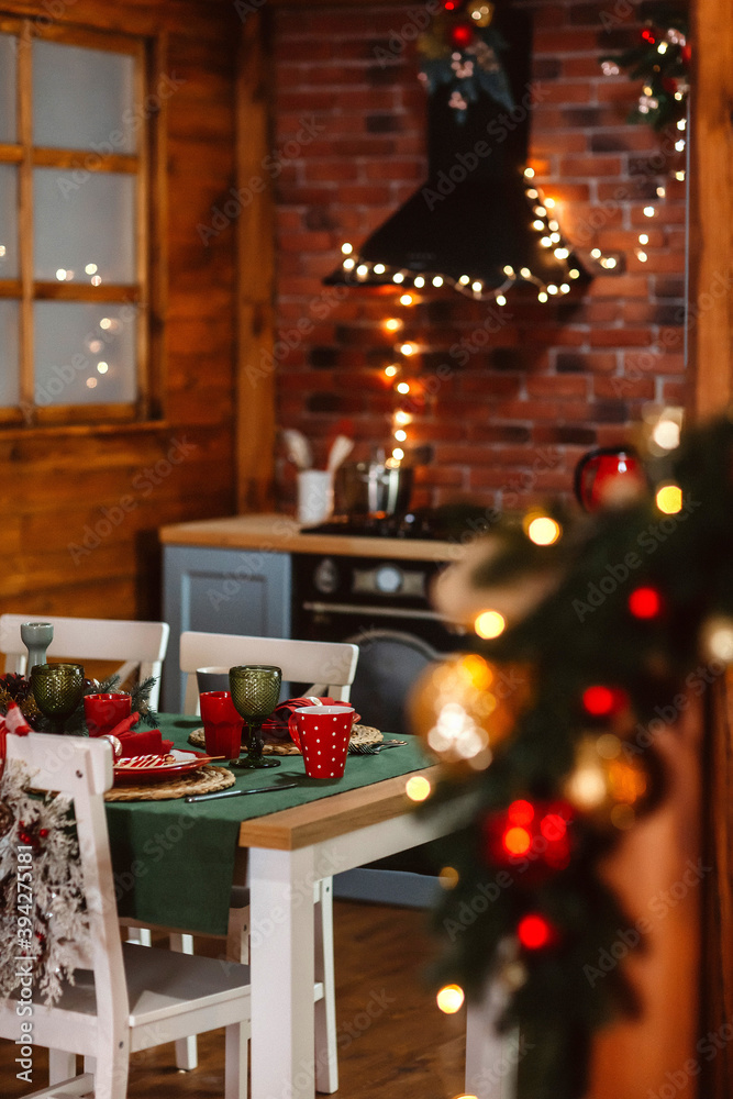 Christmas at home. Festively decorated table in the home kitchen. Vertical image.