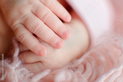 Caucasian Newborn baby hand closeup macro detail shot. child portrait  health skin  tenderness  maternity and babyhood concept - Image. Soft selective focus
