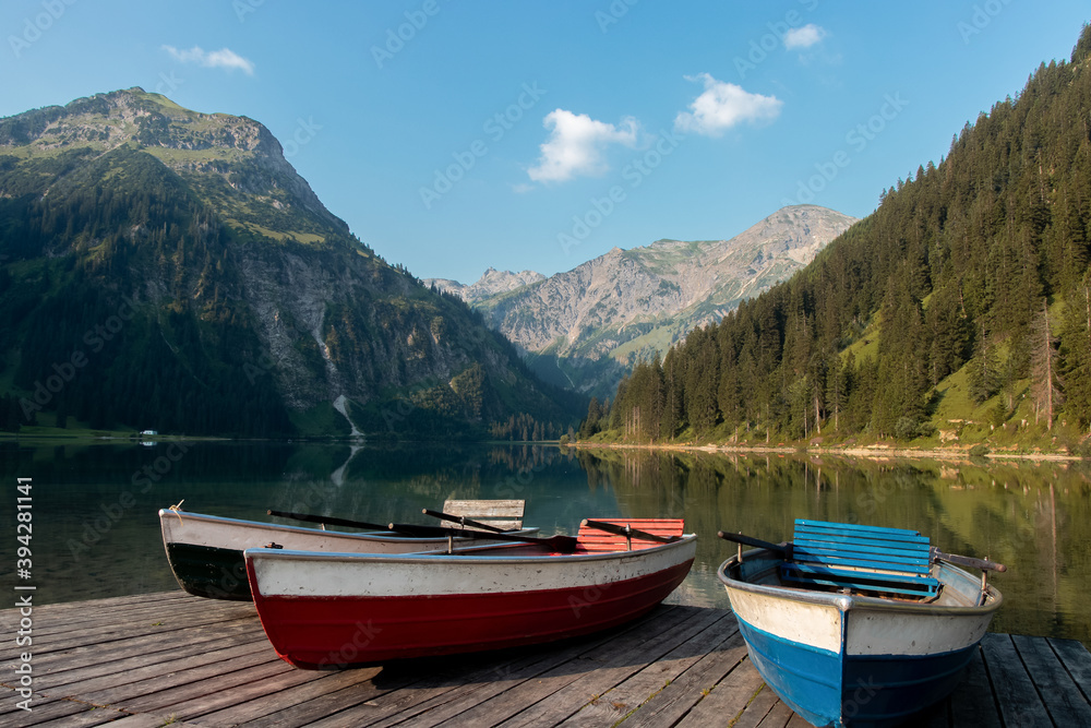 Vilsalpsee, Austria: Image of rowboats on a floating platform with beautiflu mountains in the background.