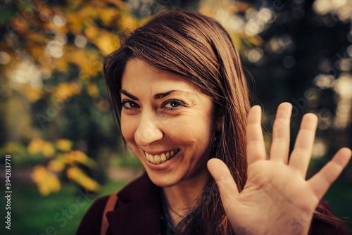 Wallpaper Mural young woman greets with her hand while smiling Torontodigital.ca