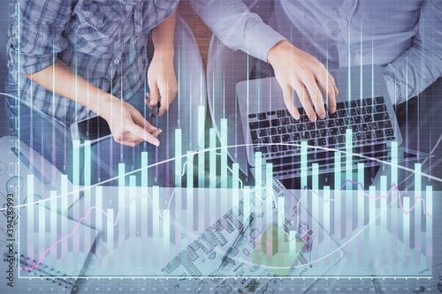 Multi exposure of man and woman working together and forex graph hologram drawing. Financial analysis concept. Computer background. Top View. © peshkova