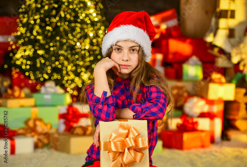 small girl xmas online shopping. delivery christmas gifts. Beautiful decorated room with tree with presents under it. new year scene with tree and gifts. Celebration holiday party