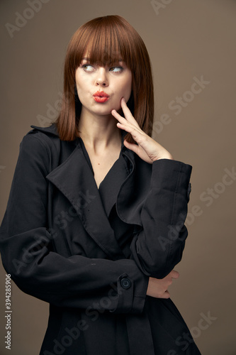 Sensual lady European appearance coat beige background