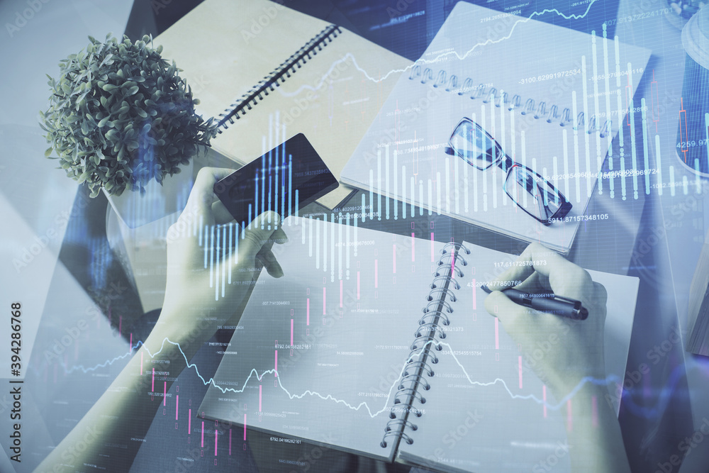 Multi exposure of woman on-line shopping holding a credit card and financial graph drawing. Stock market E-commerce concept. Multi exposure of woman on-line shopping holding a credit card and financial graph drawing. Stock market E-commerce concept.