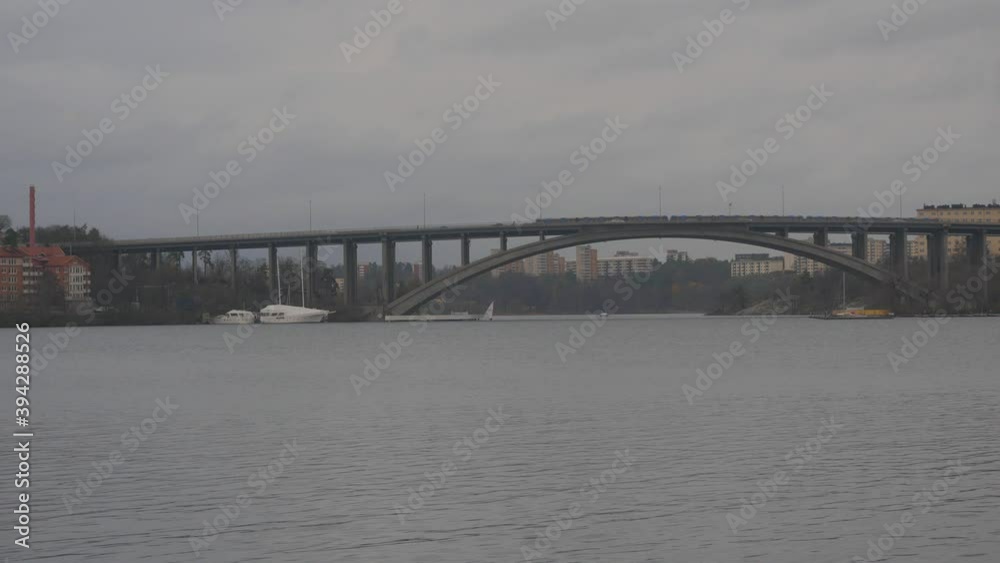 Famous bridge Tranebergsbron in Stockholm view from a distance. Subways and other vehicles share this bridge. It connects different parts of the cities islands, and it's vital for transportation. Famous bridge Tranebergsbron in Stockholm view from a distance. Subways and other vehicles share this bridge. It connects different parts of the cities islands, and it's vital for transportation.