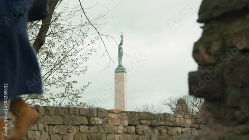 Latvia freedom monument far look, people passing by photo