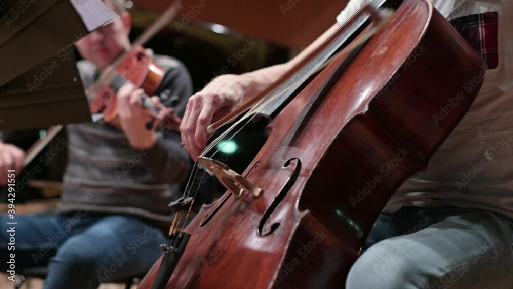 A close-up of the double bass strings as the bow slides. Playing stringed instruments in a group A close-up of the double bass strings as the bow slides. Playing stringed instruments in a group