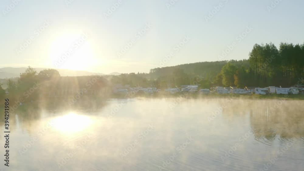 Magical view showing lake during misty morning at Pirkdorfer see campsite, Austria. Aerial. Magical view showing lake during misty morning at Pirkdorfer see campsite, Austria. Aerial.