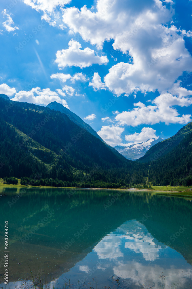 Durlassboden reservoir in the Zillertal Alps, mountain lake with reflection in austria