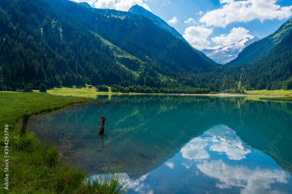 Durlassboden reservoir in the Zillertal Alsp, mountain lake with reflection in austria