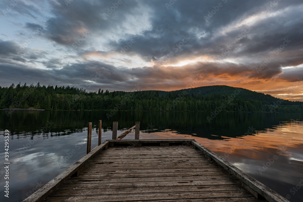 Sun setting over a wooden dock in Inland lake provincial park, British Columbia, Canada