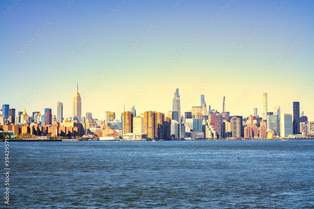 panorama of New York City skyscrapers in front of water. Skyline of New York City at sunset