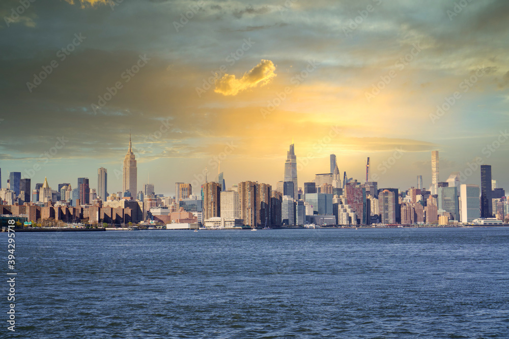 panorama of New York City skyscrapers in front of water. Skyline of New York City at sunset