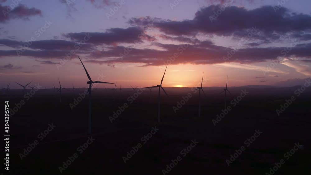 Silhouette of wind farm with sunset in background at Barahona. Aerial shot Silhouette of wind farm with sunset in background at Barahona. Aerial shot