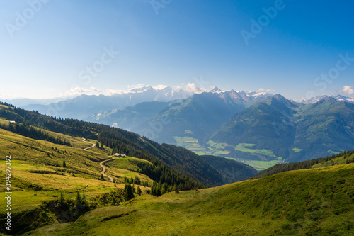 Idyllic landscape with mountain top above green pastures under a blue sky with white clouds high up in the Venediger Alps in summer. salzburg region  austria in europe