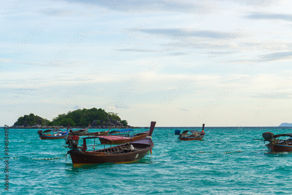 Traditional wooden longtail boat and beautiful sunset sand Beach in Lipe