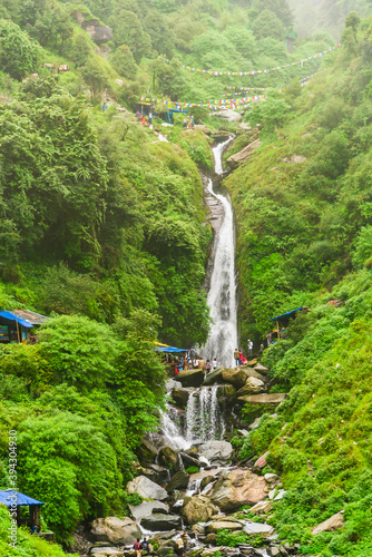 Majestic landscape of Bhagsu Nag waterfall and green forest around at Mcleodganj, Himachal Pradesh, India. photo