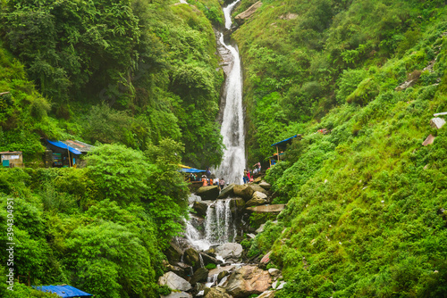 Majestic landscape of Bhagsu Nag waterfall and green forest around at Mcleodganj, Himachal Pradesh, India.
