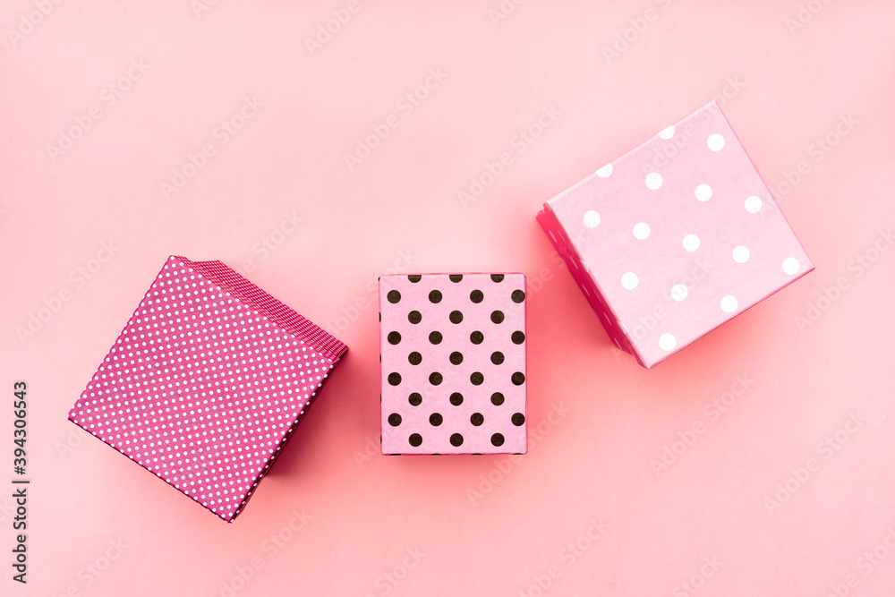 Fototapeta premium Gift boxs on paste pink background. Christmas and holiday minimal concept idea.