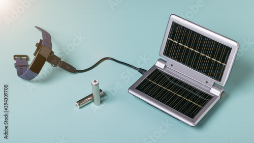 The process of charging a smart watch from the energy of sunlight. Use of solar energy.