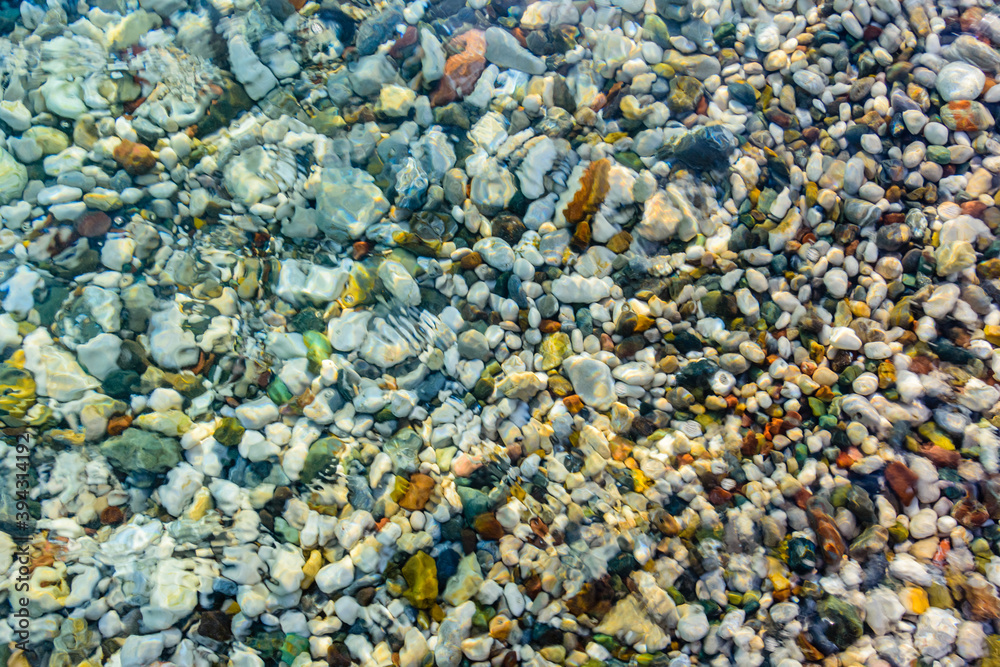 Texture of pebbles under water at the seaside. Natural background Texture of pebbles under water at the seaside. Natural background