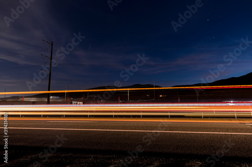 Light trails from long exposure of car traffic on a highway at sunset