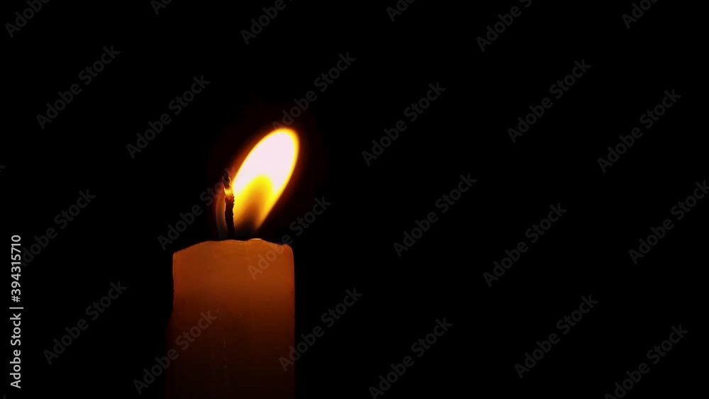 burning candle in the dark flickering by wind burning candle in the dark flickering by wind