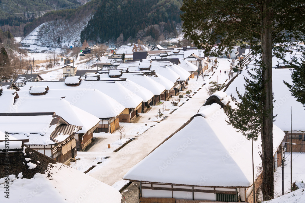 Ouchi Juku village in Fukushima, Tohoku, Japan. Thatched roof house, village made of over 30 traditional Japanese houses and snow covered street