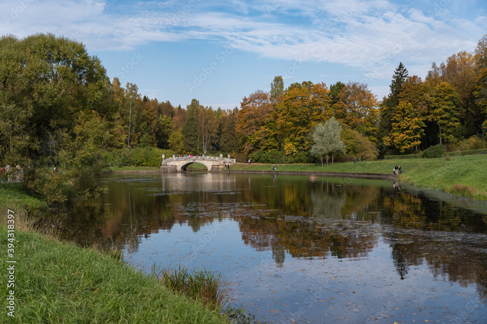 Vintage Viskontiev bridge over Slavyanka river. The autumn landscape. Pavlovsk Palace Park. Saint-Petersburg, Russia