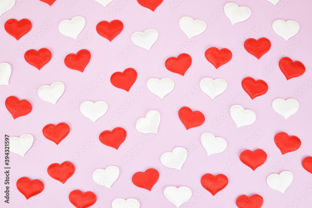 Festive pattern of red and white decorative hearts on a pink background. Valentine's day concept.