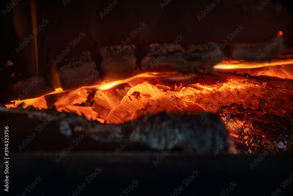 Burning firewood in the fireplace. Close up. Burning firewood in the fireplace. Close up.