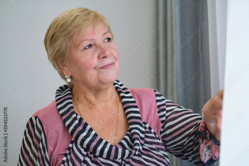 Shot of a happy senior woman smiling looking away Portrait of Elegant mature lady looking out of window. Shot of a happy senior woman smiling looking away Portrait of Elegant mature lady looking out of window.