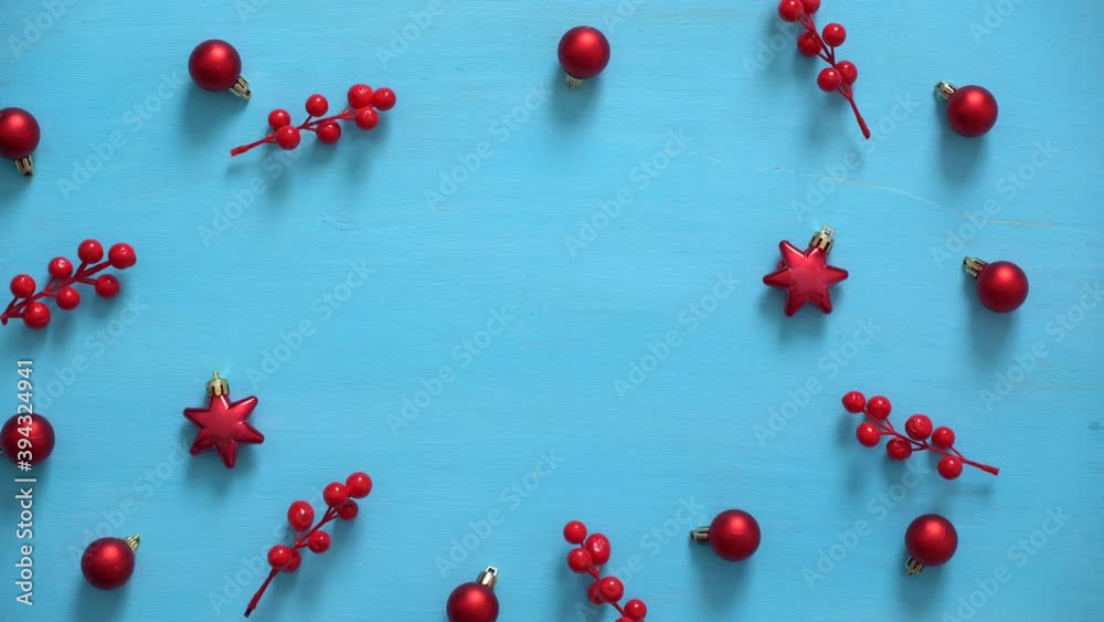 Man's hands place gift on wooden christmas background with xmas decorations Man's hands place gift on wooden christmas background with xmas decorations