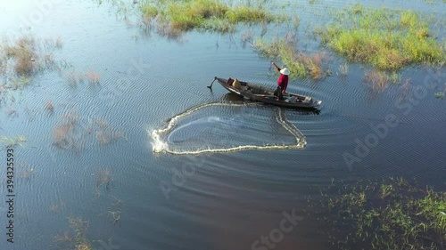 Aerial view from drone. Asian fishermen use traditional fishing nets in the lake in the morning.