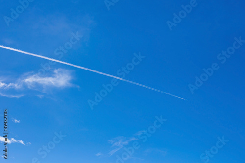 Contrail in blue sky with white cloud . Sky cloud. 