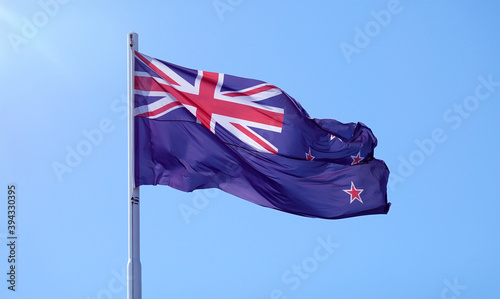 Bild auf Leinwand New Zealand flag flying on blue sky