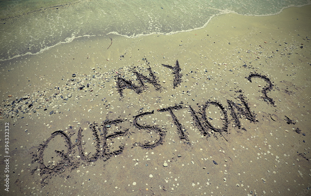 Fototapeta premium text any question written in the sand of the beach by the sea