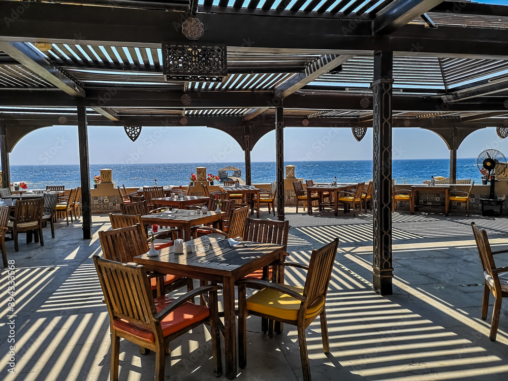Fototapeta premium restaurant with stripped shadow on a terrace