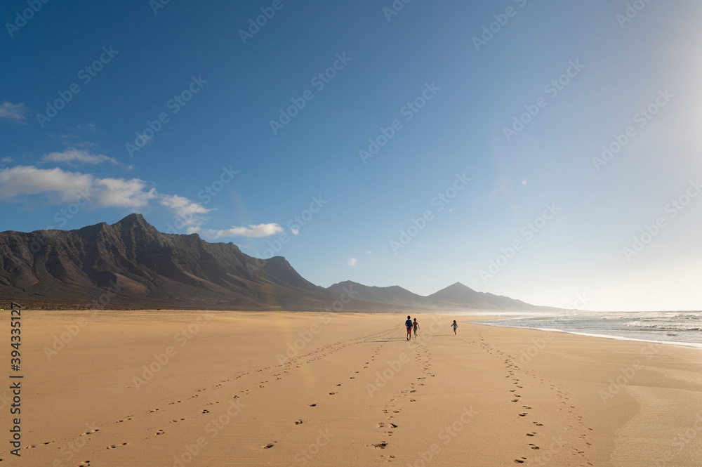 Children walking on Cofete beach, Fuerteventura island