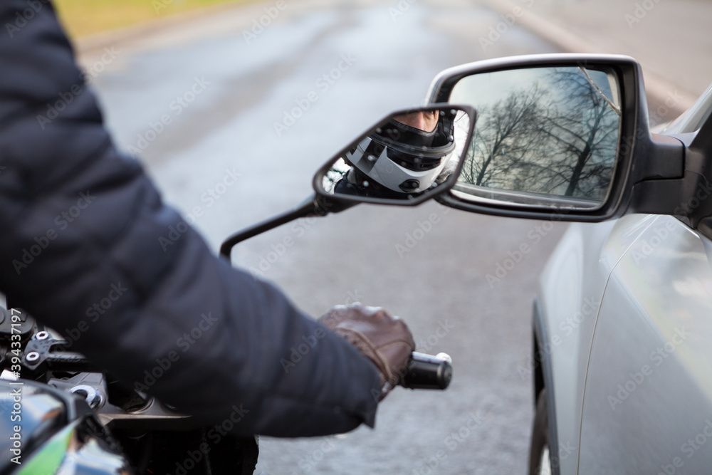 Motorcyclist does not keep distance while riding side by side with a car, side mirrors touching Motorcyclist does not keep distance while riding side by side with a car, side mirrors touching