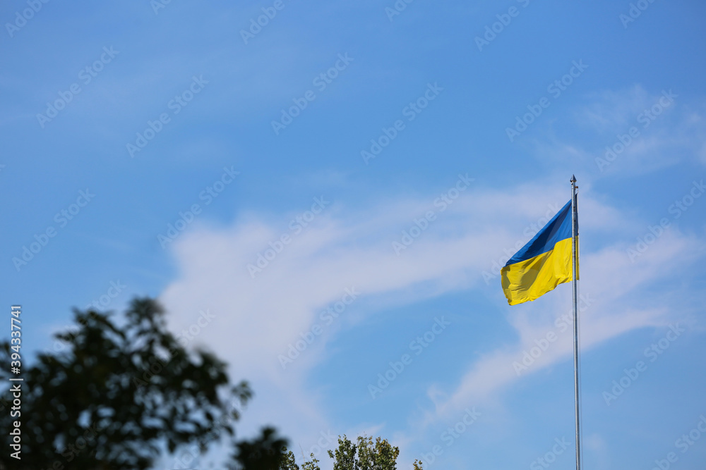 Fototapeta premium National flag of Ukraine against blue sky