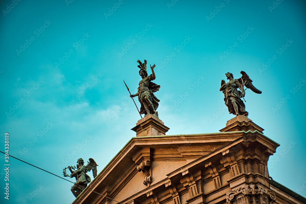 Statues touched by sunshine on the top of San Giorgio al Palazzo church , which is a baroque-style, Roman Catholic church in central Milan Statues touched by sunshine on the top of San Giorgio al Palazzo church , which is a baroque-style, Roman Catholic church in central Milan