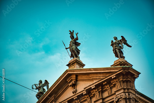 Statues touched by sunshine on the top of San Giorgio al Palazzo church , which is a baroque-style, Roman Catholic church in central Milan