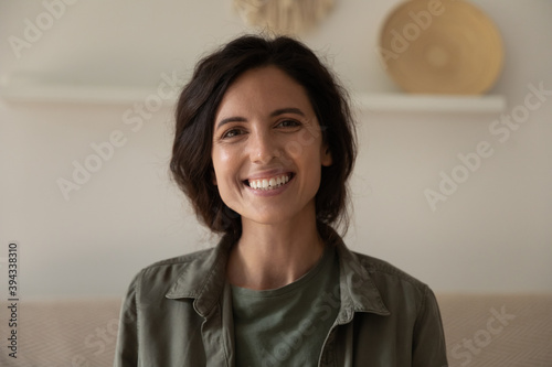Profile picture of happy millennial caucasian woman posing in own new home apartment. Close up headshot portrait of smiling female renter or tenant satisfied with real estate agency services.