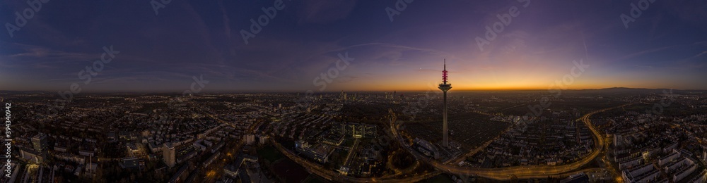 Drone image of the Frankfurt skyline with television tower in the evening during a colorful and impressive sunset
