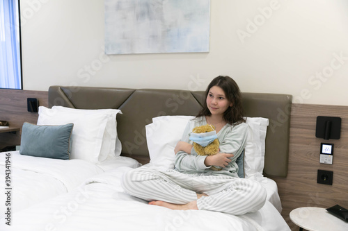 Girl with a Teddy bear, with a favorite toy on Sunday morning in bed very happy
