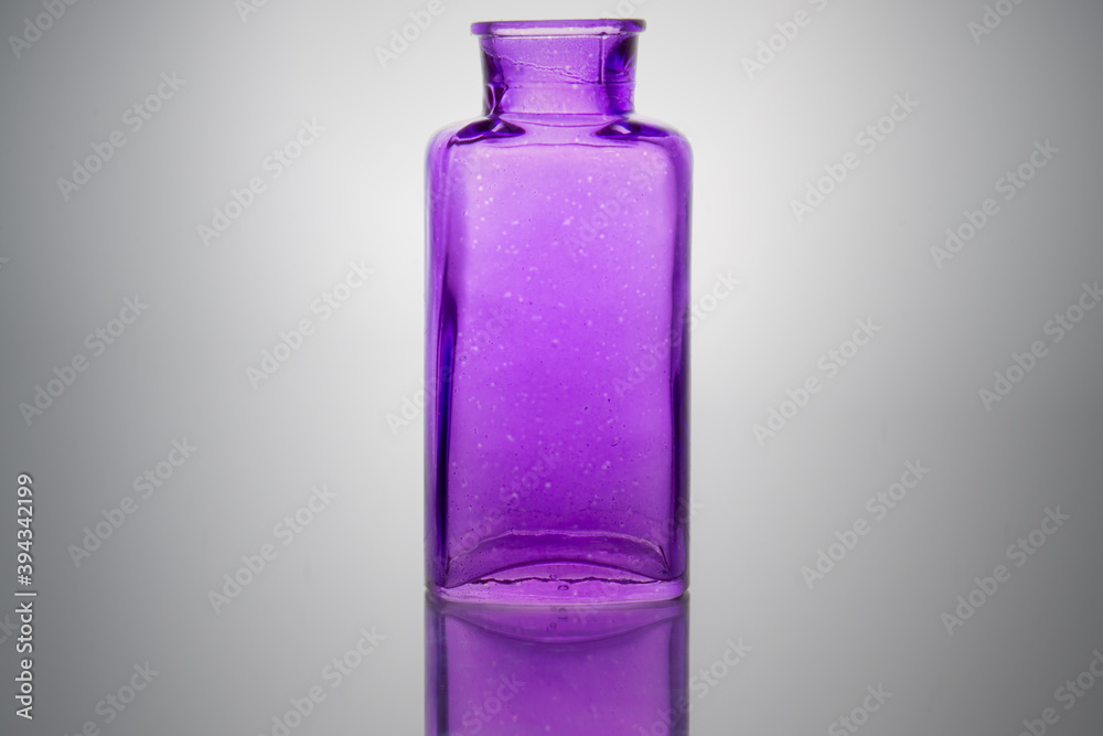 Old bottle of purple color on a light background Old bottle of purple color on a light background