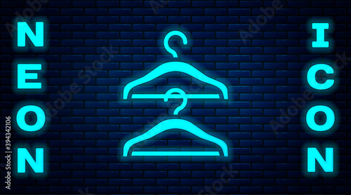 Glowing neon Hanger wardrobe icon isolated on brick wall background. Cloakroom icon. Clothes service symbol. Laundry hanger sign. Vector.