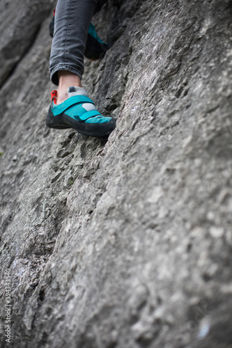 Person climbing while wearing rock climbing shoes