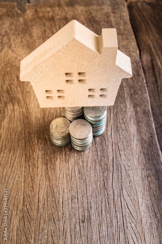 Wood sweet home model and business coin finacial on table